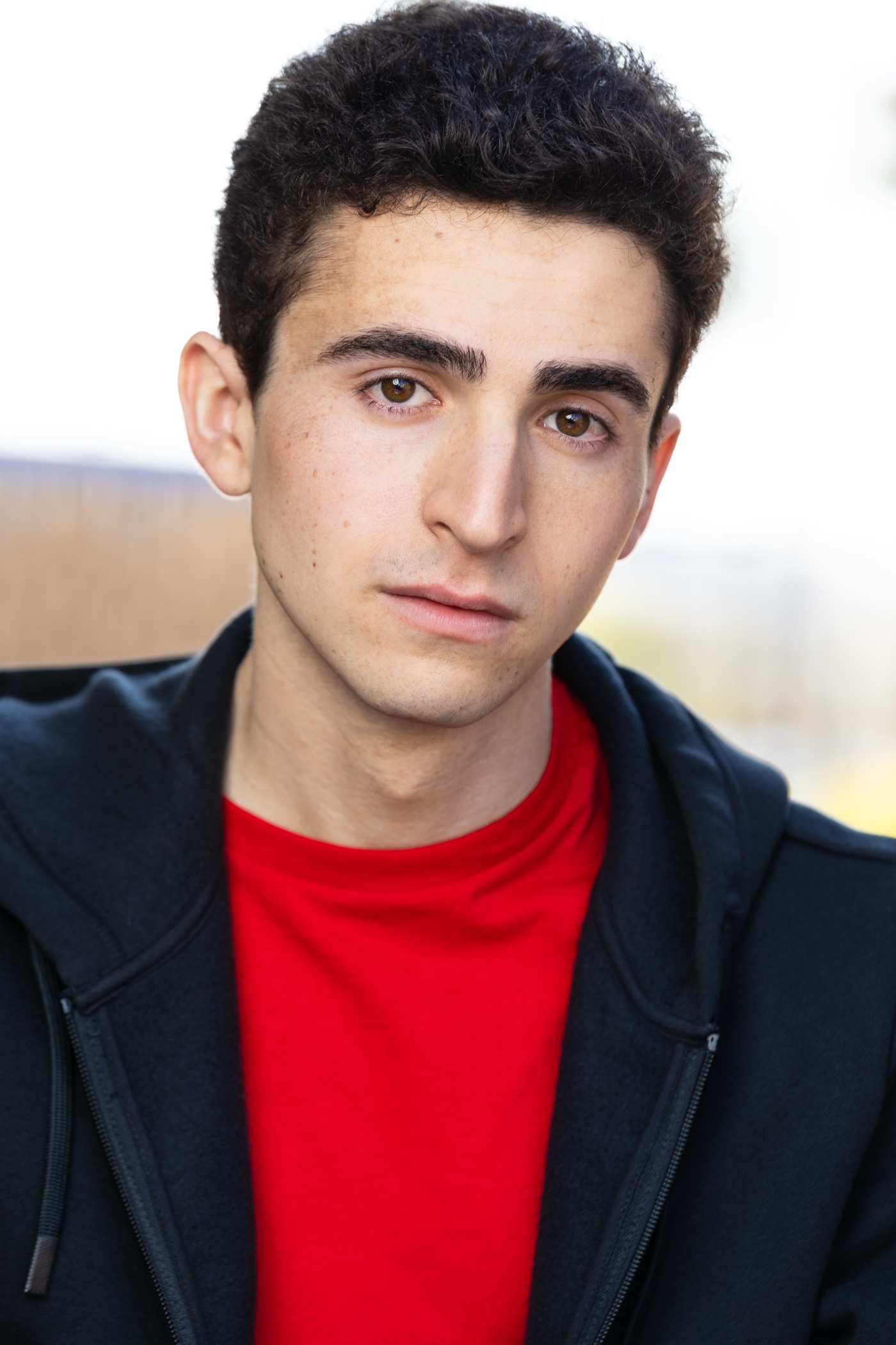 David Landis headshot in a red shirt